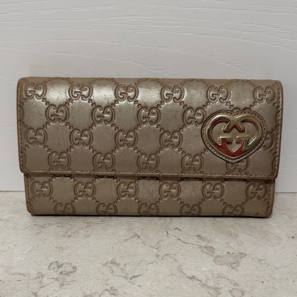Gucci Handbags - Gucci Gold Embossed Leather Wallet